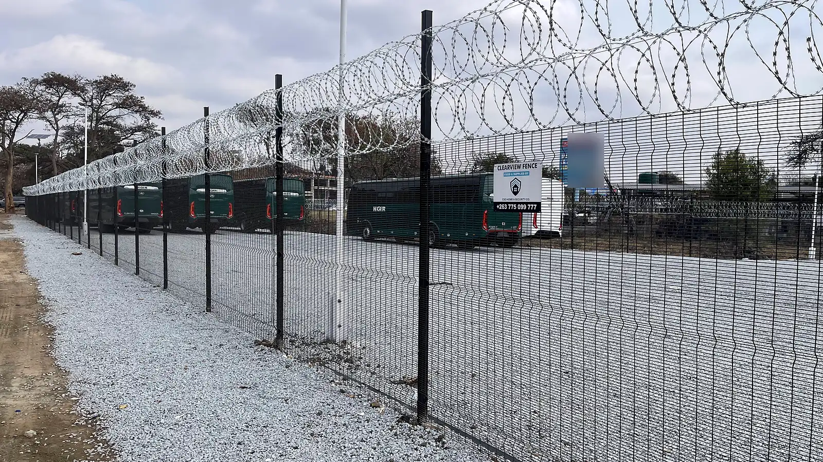 Black Clearview security fence with razor wire around a commercial vehicle yard in Eastlea, Harare, installed by CSO